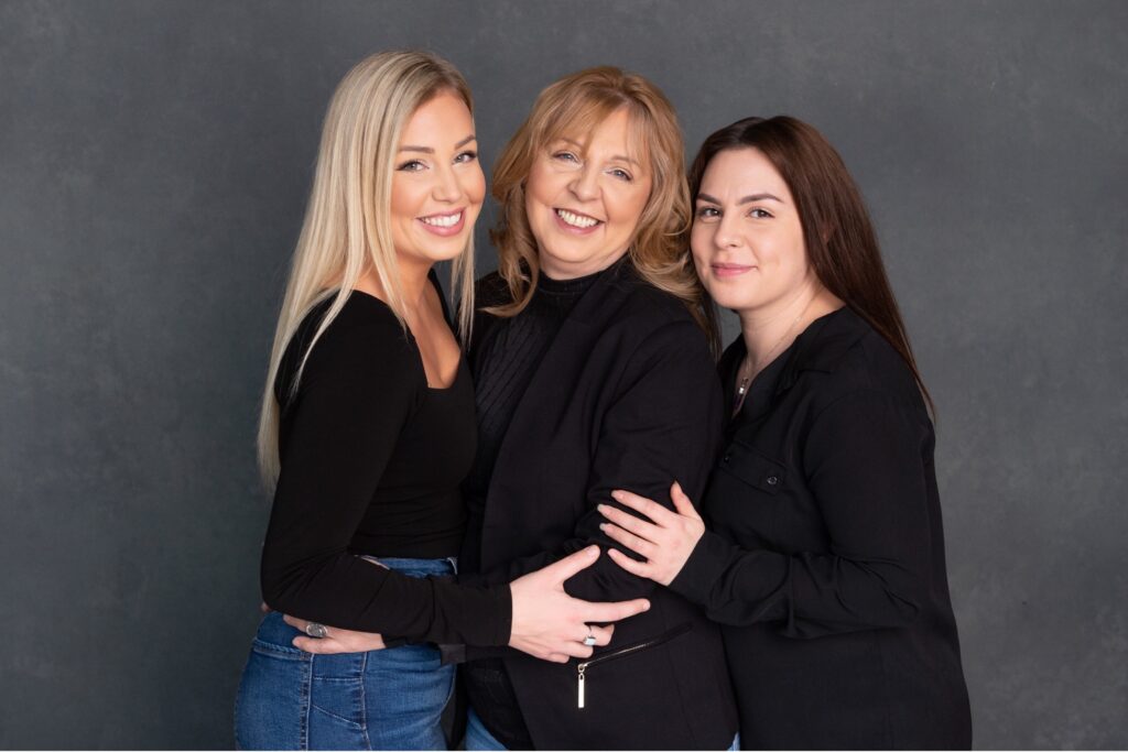 three women on a black backdrop