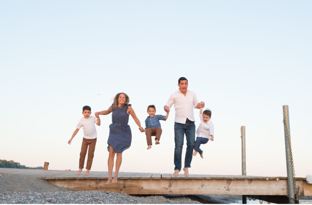 family on the beach jumping
